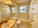 Bright bathroom with a shower-tub combo, vanity, and tile flooring at 3370 Cypress Point Cir, St Cloud, FL 34772