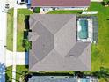 Aerial view of a home's roof and fenced-in pool, demonstrating its layout and outdoor amenities at 426 Prestwick Dr, Davenport, FL 33897