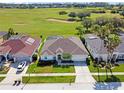 Overhead view of a single-story home showing the proximity to a beautiful golf course and screened in patios at 426 Prestwick Dr, Davenport, FL 33897