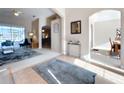Open-concept living room showcasing arched doorways and neutral color palette with plush carpet at 518 Brighton Dr, Davenport, FL 33897