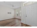 Bright entryway with wood floors, white door and trim, and ample natural light at 7013 Beargrass Rd, Harmony, FL 34773