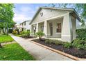 Well-maintained home exterior featuring manicured landscaping and a cozy front porch at 7013 Beargrass Rd, Harmony, FL 34773