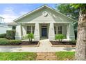 Charming single-story home with a welcoming front porch and neatly landscaped yard at 7013 Beargrass Rd, Harmony, FL 34773