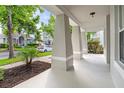 Inviting front porch with sturdy columns, offering a comfortable outdoor space at 7013 Beargrass Rd, Harmony, FL 34773