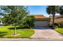 A well-maintained home with a two-car garage and a brick paved driveway at 803 Shady Canyon Way, Kissimmee, FL 34759