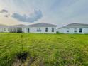 View of the expansive backyard featuring lush green grass at 1190 Lexington Lane, Haines City, FL 33844