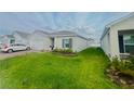 Well-maintained one-story home featuring a lush lawn and mature landscaping at 1190 Lexington Lane, Haines City, FL 33844