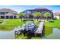 Lakeside home featuring a private boat dock, perfect for enjoying waterfront activities and scenic views at 1211 Terralago Way, Kissimmee, FL 34746