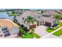 Aerial view of a luxurious home with a beautiful tile roof and a private lake in the backyard at 1211 Terralago Way, Kissimmee, FL 34746