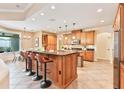 Spacious kitchen boasts a large island with seating, stainless steel appliances, and ample cabinetry at 12649 Dallington Ter, Winter Garden, FL 34787