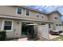 The cozy patio features an outdoor dining set, privacy fence, and sliding glass doors to the interior at 13885 Arclid St, Orlando, FL 32832