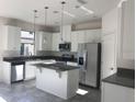 Bright kitchen with stainless steel appliances, granite countertops, and a functional island at 13885 Arclid St, Orlando, FL 32832