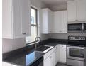 Close-up of a modern kitchen featuring granite countertops and stainless steel appliances at 13885 Arclid St, Orlando, FL 32832