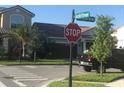 Street corner with a stop sign and lush greenery in a residential neighborhood at 13885 Arclid St, Orlando, FL 32832