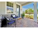Inviting front porch with brick flooring, comfortable seating, and stylish decor at 14389 Lanikai Beach Dr, Orlando, FL 32827