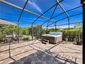 Spacious screened patio featuring a hot tub, perfect for relaxation and entertaining at 1470 Lake Side Ave, Davenport, FL 33837
