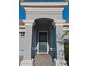 This home features a welcoming, arched front entry with stately columns and a beautifully tiled walkway leading to a dark blue front door at 1508 Bunker Drive Bunker, Davenport, FL 33896