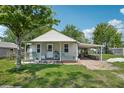 Inviting home with a covered porch, a carport, and well-maintained front lawn at 1626 Gar St, St Cloud, FL 34771