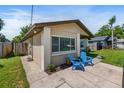Exterior side view of a cozy home with a well-kept lawn, and concrete walkway at 1712 Melvin Ave, Orlando, FL 32806