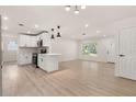 Open-concept living room and kitchen with light wood floors and recessed lighting throughout the space at 1842 Puritan Ave, Winter Park, FL 32792
