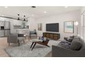 Open-concept living room with a modern design and updated kitchen appliances at 1842 Puritan Ave, Winter Park, FL 32792