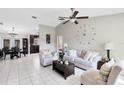 Bright living room featuring neutral tones, tile flooring, and elegant furnishings at 2454 Quail Run N Blvd, Kissimmee, FL 34744