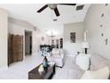 Spacious living room with tile flooring, featuring an open layout to the dining area at 2454 Quail Run N Blvd, Kissimmee, FL 34744