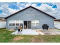 Back exterior featuring a patio area, sliding glass door, and a grill at 2507 Talega Dr, St Cloud, FL 34772
