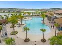 Aerial view of a resort-style pool with lush landscaping and plenty of lounge chairs at 2621 Amati Dr, Kissimmee, FL 34741
