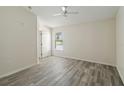 Bedroom with ceiling fan, wood-look floors, and natural light at 2826 Club Cortile Cir # B, Kissimmee, FL 34746