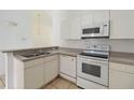 Bright kitchen featuring white appliances and ample cabinet space at 2826 Club Cortile Cir # B, Kissimmee, FL 34746