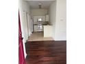 View of the kitchen with white appliances, tile floors, and white cabinets at 2828 Club Cortile Cir # B, Kissimmee, FL 34746