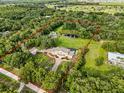 Sprawling property outlined in red, surrounded by lush greenery and mature trees for ultimate privacy at 2851 Wagon Ct, St Cloud, FL 34772
