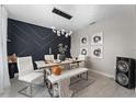 A modern dining room featuring a stylish light fixture, seating for six, and decorative wall art at 3053 Royal Tern Dr, Winter Haven, FL 33881
