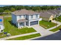 Aerial view of a modern two-story home with a well-kept lawn in a residential neighborhood at 3053 Royal Tern Dr, Winter Haven, FL 33881