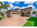 Attractive two-story home features a brick driveway, two-car garage, and well-maintained landscaping at 3159 Somerset Park Dr, Orlando, FL 32824