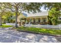 Charming yellow home with a white picket fence and lush landscaping at 3349 Schoolhouse Rd, Harmony, FL 34773