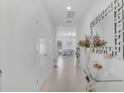 Bright entryway with white walls, tile floors, decorative mirror, and console table at 3400 Mt Vernon Way, Kissimmee, FL 34741