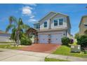 Charming two-story home featuring a brick driveway, two-car garage, and well-maintained landscaping at 3400 Mt Vernon Way, Kissimmee, FL 34741