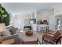 Open concept living space with modern furniture, tv, kitchen bar, and view of the front door at 344 High Point Dr, Davenport, FL 33837