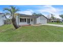 Lovely home with a well-manicured lawn and mature landscaping including a palm tree at 5627 Marvell Ave, Orlando, FL 32839