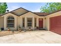 Inviting exterior showcasing a manicured front yard and charming architectural details at 621 Rebecca Dr, St Cloud, FL 34769