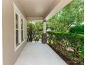 View of covered front porch with stone accents, offering a charming entrance to this beautiful home at 6957 Northwich Dr, Windermere, FL 34786