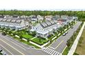 Aerial view of a residential neighborhood with well-manicured lawns and sidewalks at 7400 Estuary Lake Loop, Celebration, FL 34747