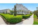 Inviting townhome with a white porch railing and lush green landscaping at 7400 Estuary Lake Loop, Celebration, FL 34747