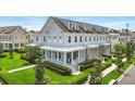 A stylish townhome featuring a welcoming front porch and well-maintained landscaping at 7400 Estuary Lake Loop, Celebration, FL 34747