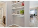 Stylish entryway with built-in shelving and hooks, leading into an open-concept living space at 8042 Glenlloyd Ave, Winter Garden, FL 34787