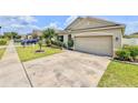 Attractive single-story home featuring a 2-car garage, landscaped front yard with stone edging, and lush green grass at 810 Jefferson Blvd, Haines City, FL 33844