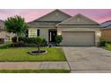 Charming single-story home with a well-manicured lawn, beautiful landscaping, and a two-car garage at 810 Jefferson Blvd, Haines City, FL 33844