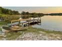 Scenic view of a private dock with a boat, perfect for enjoying lakeside living and water activities at 822 S Breen Rd, Lake Wales, FL 33898
